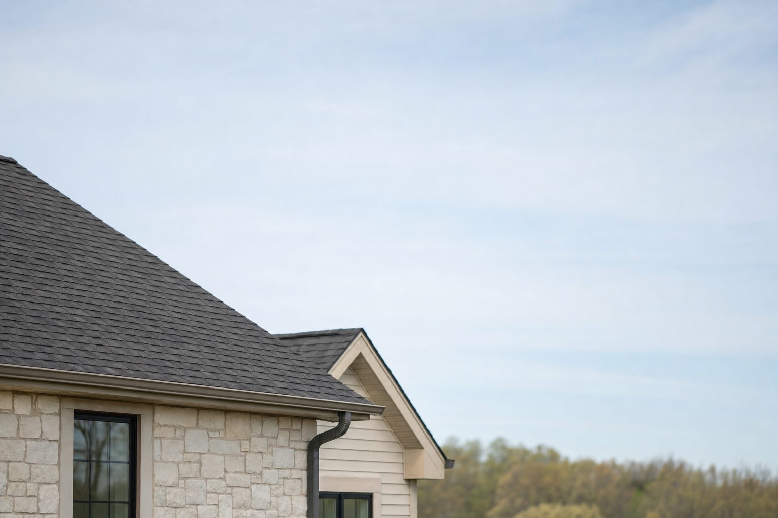 Well-kept residential property with finished roofing work and clear open sky